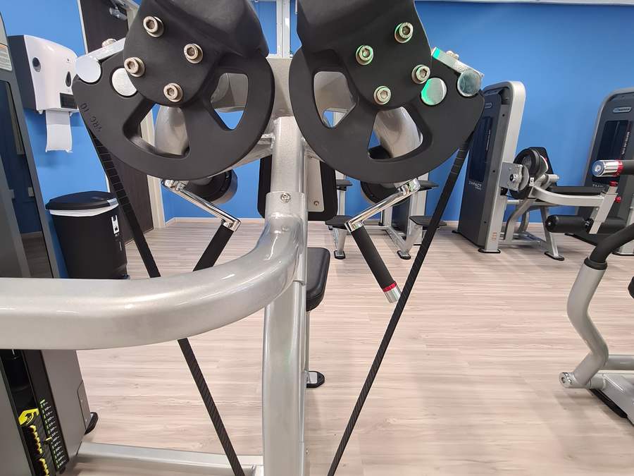 Close view of the Nautilus cams and converging press arms that vary resistance through the movement