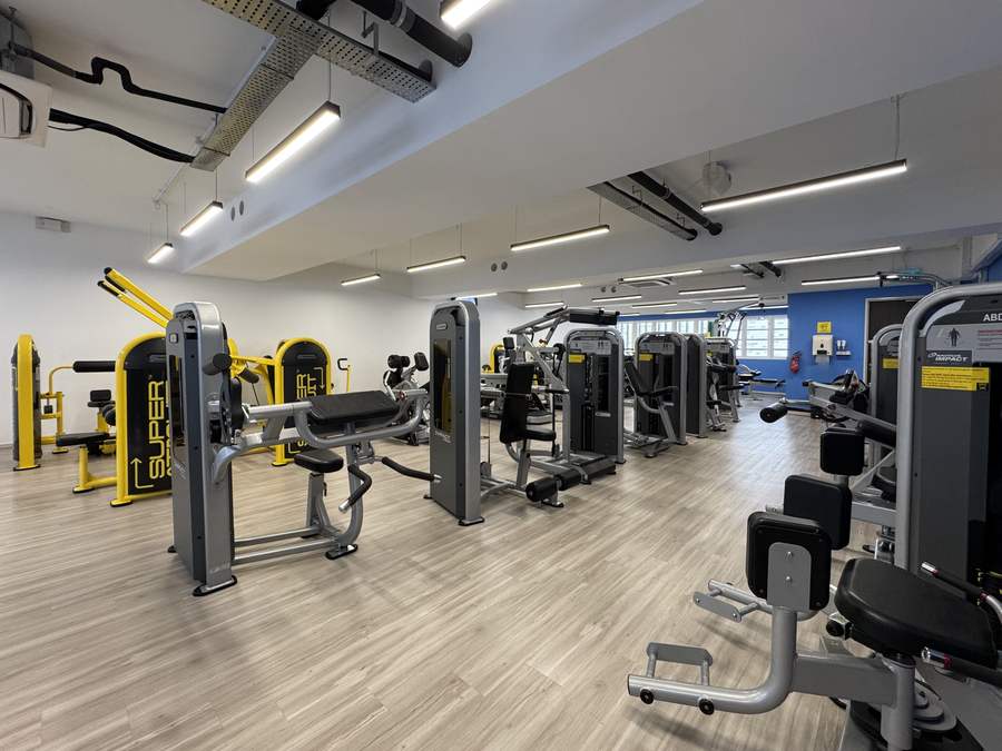 Wide view of the machines floor with rows of Nautilus Impact selectorised machines and yellow Super Circuit stations
