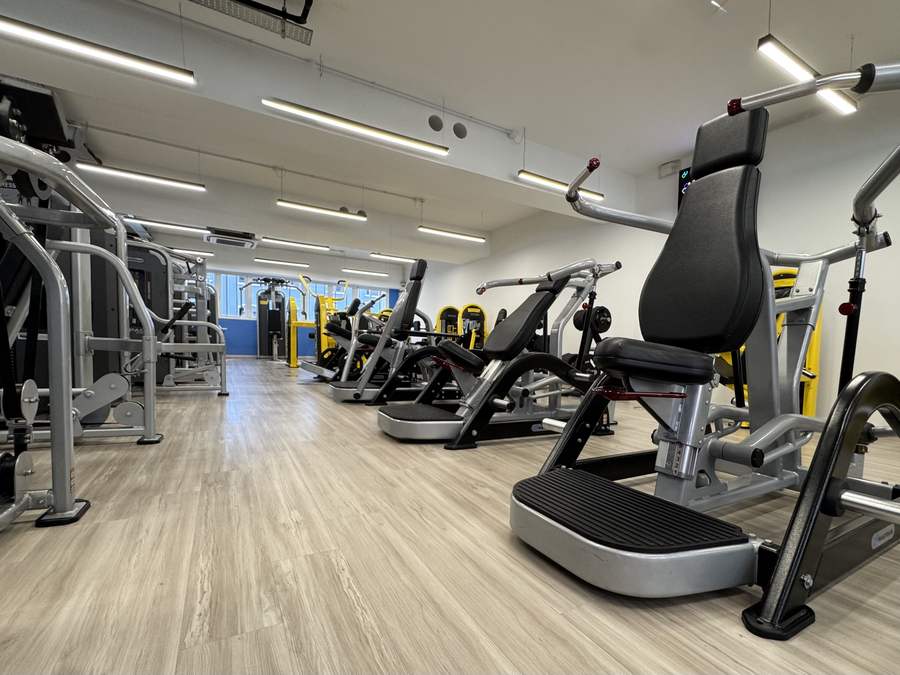 Row of plate-loaded Nautilus Leverage machines including chest press and incline press