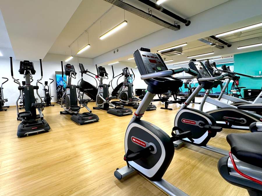 Star Trac upright bikes and ellipticals spread across the cardio floor