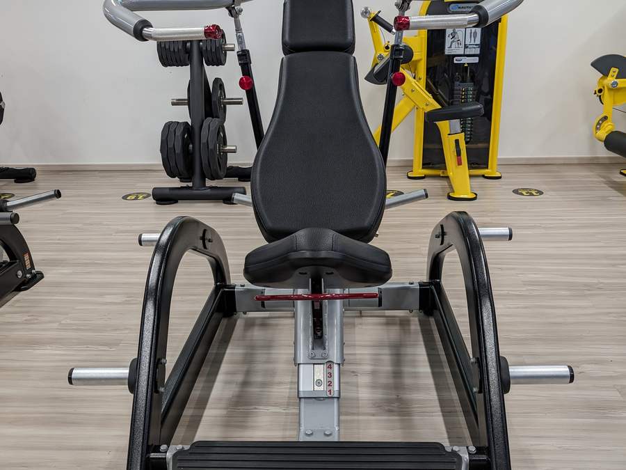 Nautilus Leverage plate-loaded chest press seen head on, with a numbered Super Circuit floor marker in front